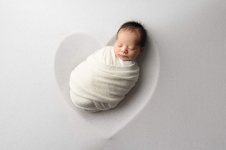Infant surrounded by love at Newborn Photography Experience